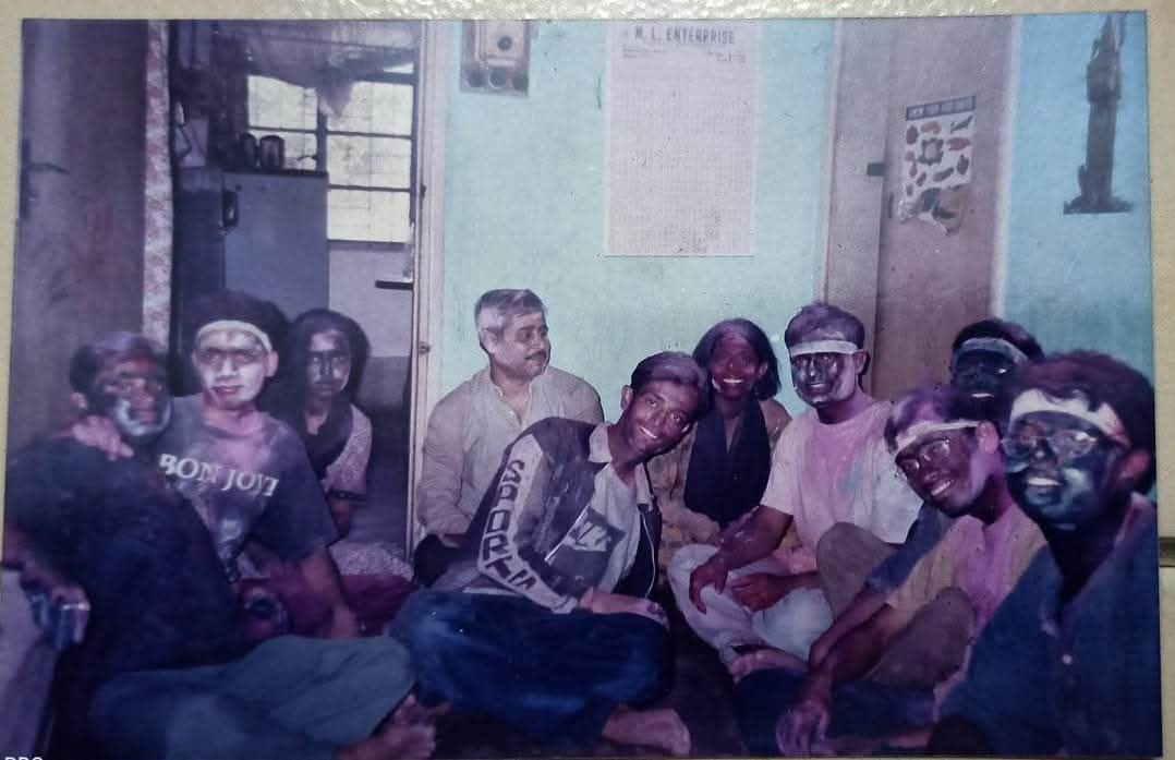 Batchmates covered in colours celebrating Holi in a hostel room