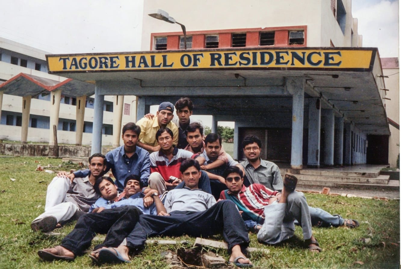 Batchmates lounging on the grass in front of Tagore Hall of Residence